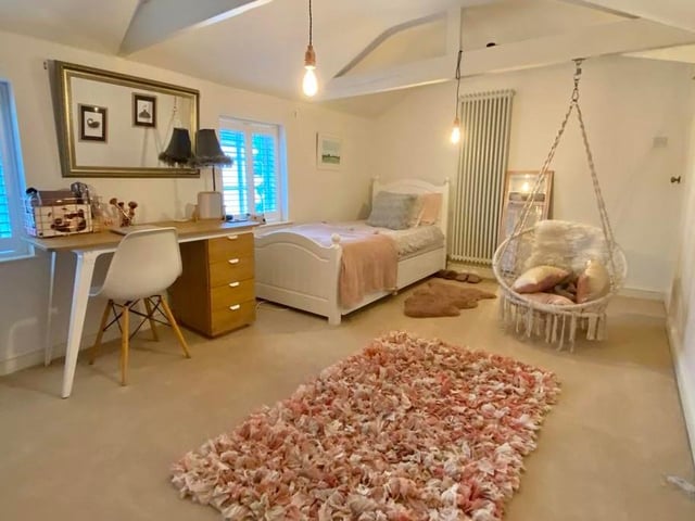 The second bedroom is spacious and stylish. It has two double-glazed windows to the front, exposed roof timbers and a vertical radiator.