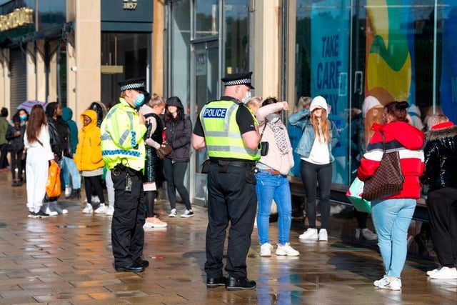 Police officers patrolled outside the Primark store in Edinburgh as shoppers queued to go inside