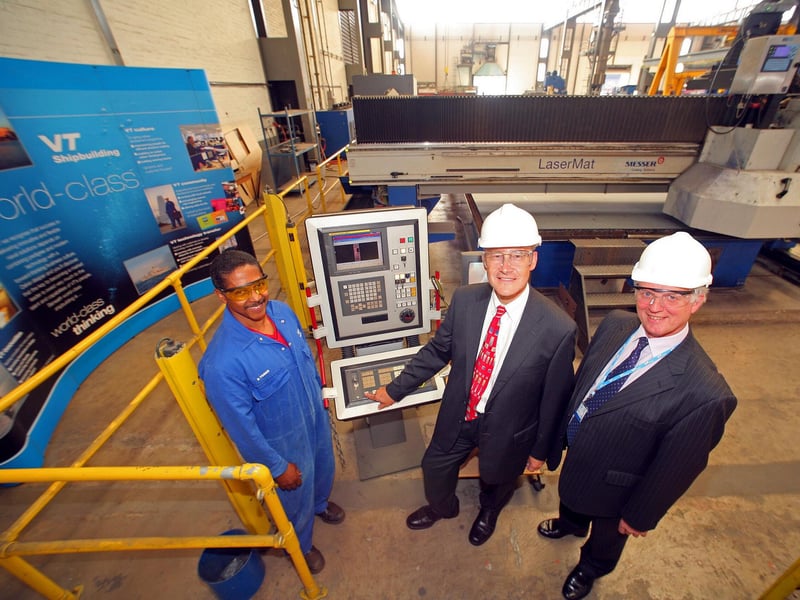 First steel cut at VT Shipbuilding in Portsmouth naval base on the fifth Type 45 destroyer, HMS Defender.
HMS Defenders start (l to r) VT Shipbuilding laser cutter operator Benny Yorke, MoD project team leader Matt Roberts and VT Shipbuilding Managing Director Geoff Smith.