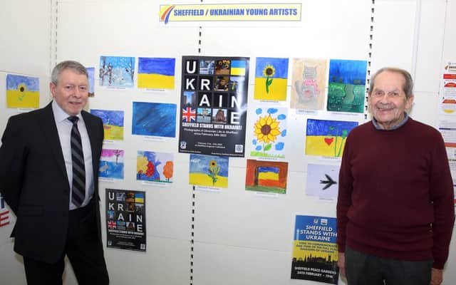 Ken Marshall of Sheffield Young Artists (right) and Peter Clark, managing partner at Graysons, unveil the art from the children of Ukraine.