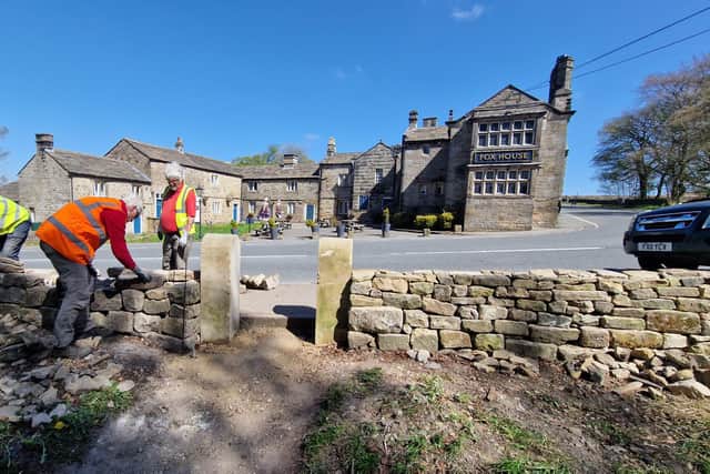 National Trust volunteers rebuild wall at Longshaw near Fox House pub in May.