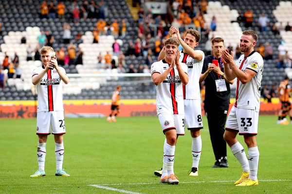 Tommy Doyle, Oliver Arblaster, Sander Berge and Rhys Norrington-Davies applaud Sheffield United's supporters after victory at Hull: Simon Bellis / Sportimage
