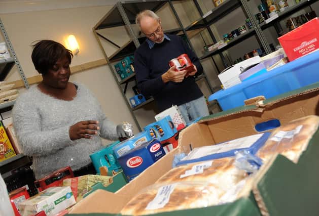 Annette Matam and Nick Twite organise a food parcel at the S2 Food Bank. Picture: Andrew Roe