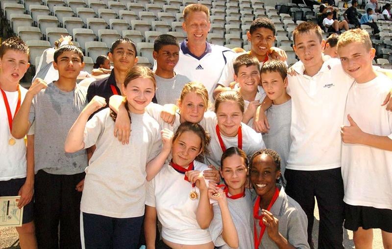 Former Olympic hero and head of PE at Firth Park C.A. College,  John Sherwood (centre rear), with some of the pupils who took part in a sports day to mark his retirement (July 12, 2006)