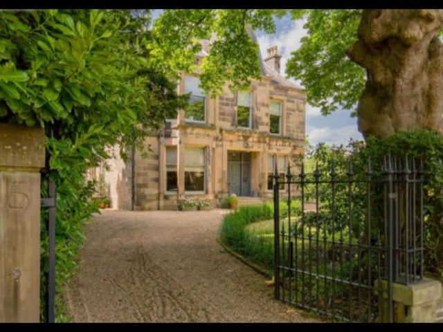 The property is nestled on a large, private plot which is accessed through two sets of wrought iron security gates. The gravel driveway along with the double garage provides parking for multiple vehicles.