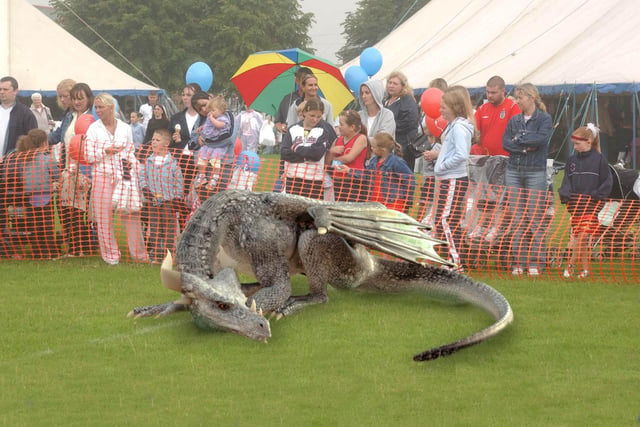 By 2004, visitors to the Southwick Carnival had tired of one regular attraction; Gorok the fire-breathing dragon. In this photo from his last year at the event, Gorok snoozes near the crowds while their attention is focused on a demonstration of Sunderland's first wireless modem.