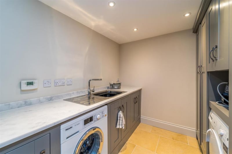 The utility room has floor to ceiling units plus base units with a stone resin worktop. There is a stainless steel sink and space to accommodate a washing machine and drier.
