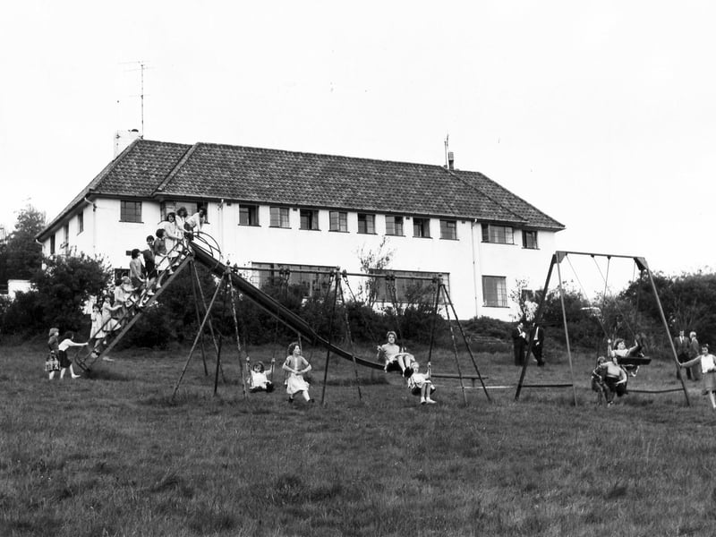 Children enjoying the swings and slide at the Fairthorn Children's Convalescent Home, Dore, Sheffield, in the 1960s