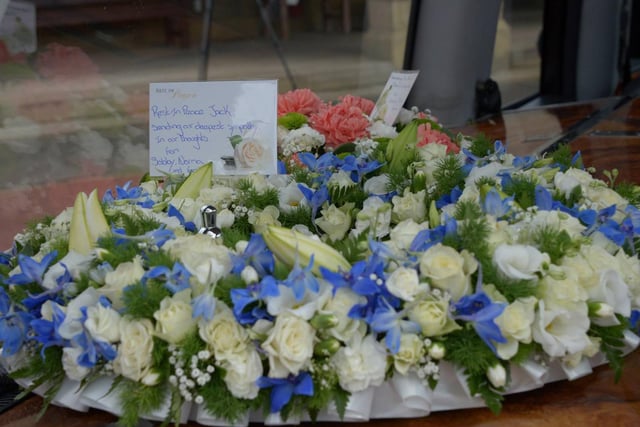 Tributes included flowers and a message from brother Sir Bobby and his family.