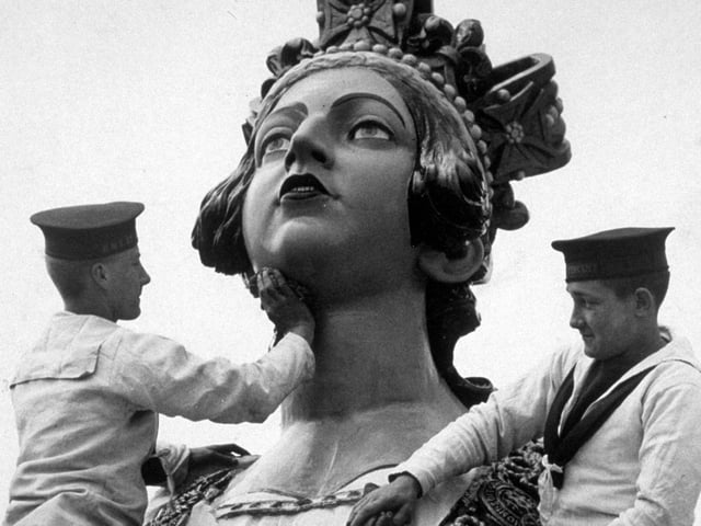 5th April 1934:  Sailors from the naval training college at Gosport, giving a statue of HM Queen Victoria a soap and water wash.  (Photo by Reg Speller/Fox Photos/Getty Images)