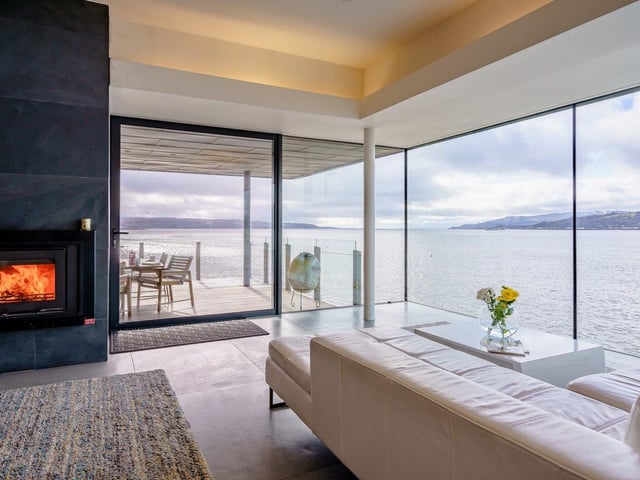 Guests can enjoy the panoramic views by the fire in the living room.