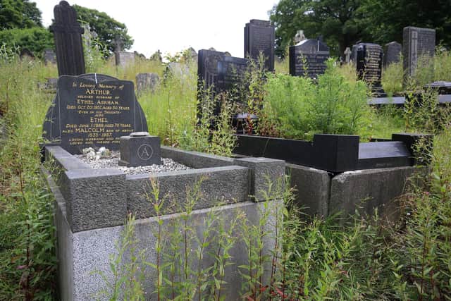 The graves at the cemetery are covered in long grass and weeds. Picture by Chris Etchells