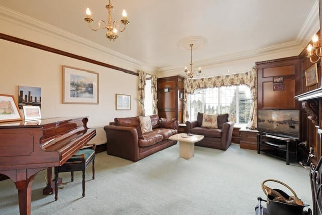 The lounge is a generously-sized reception room with character features. Two of the walls have wainscot panelling with integrated cupboards and glazed shelving. The feature point of the room is the fireplace with an oak mantel, cast iron/tiled surround and a tiled hearth with a fender.