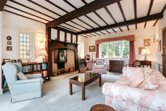 The living room has a feature fireplace with a picture window overlooking the gardens.