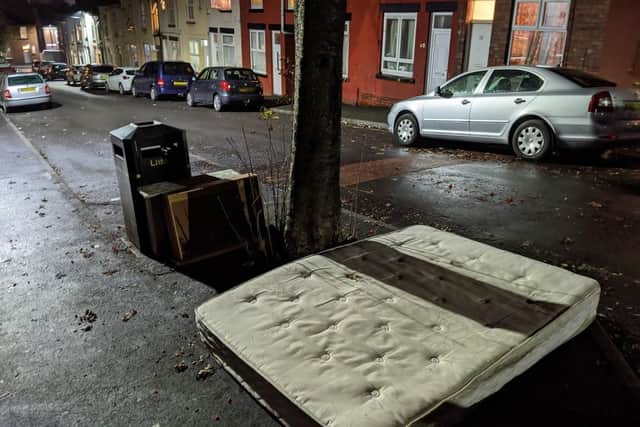 Several mattresses were dumped in the street.