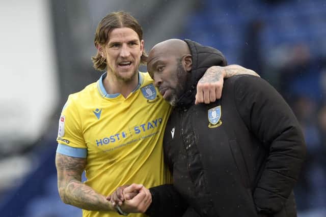 Owls Aden Flint with his manager Darren Moore at the final whistle   PIc Steve Ellis