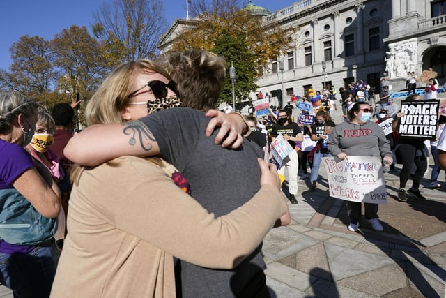 Jen Valley, of Hummelstown, Pa., and Carrie Fowler, of Harrisburg, Pa., embrace outside the Pennsylvania State Capitol (AP Photo/Julio Cortez)