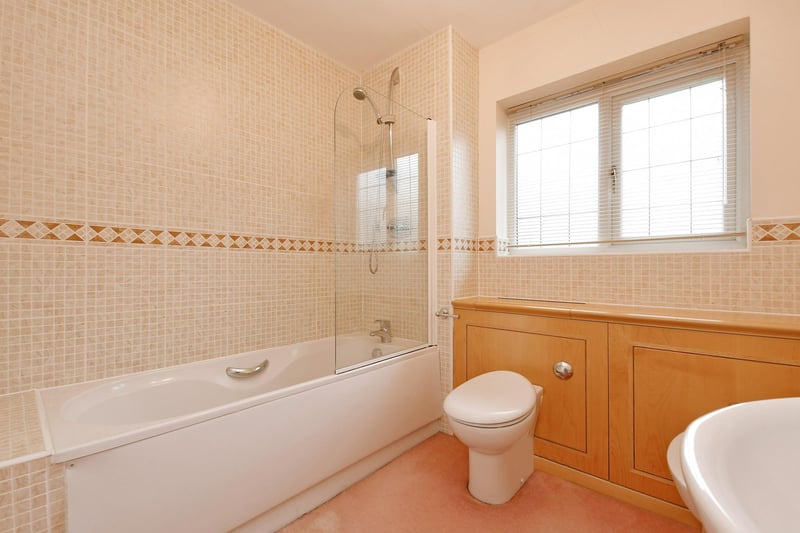 The family bathroom has partially tiled walls, chrome heated towel rail and under floor heating. There’s an Ideal Standard suite in white, which comprises of a low-level WC, a bidet with a chrome mixer tap and a vanity unit incorporating a wash hand basin with a chrome mixer tap and storage beneath. To one corner, there’s a panelled bath with a chrome mixer tap, fitted shower and a glazed screen.