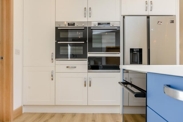 The kitchen also benefits from integrated modern appliances including a double oven, microwave, pan warmer, induction hob with pop up extractor, dishwasher and an American style fridge freezer.