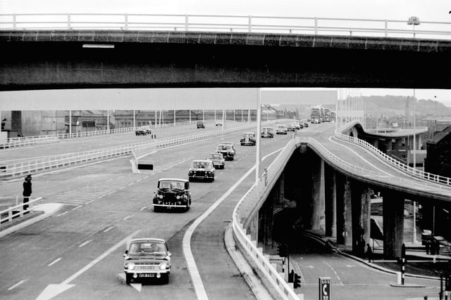 A police car leads the cavalcade when Queen Elizabeth the Queen Mother visits Glasgow to open the Kingston Bridge in June 1970.