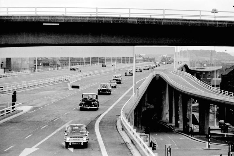 A police car leads the cavalcade when Queen Elizabeth and the Queen Mother visits Glasgow to open the Kingston Bridge in June 1970.