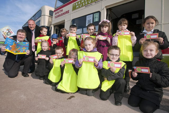 Children from Ryecroft School in Rawmarsh, Rotherham celebrate World Book Day in March 2012 at Parkgate Shopping Rotherham with the help of Billy Smith, Savills area property manager, far left, and Denis Copeland, Parkgate Shopping manager