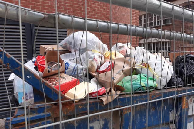 Rubbish piled high in a skip outside the Lightbox apartment block on Earl Street in Sheffield city centre