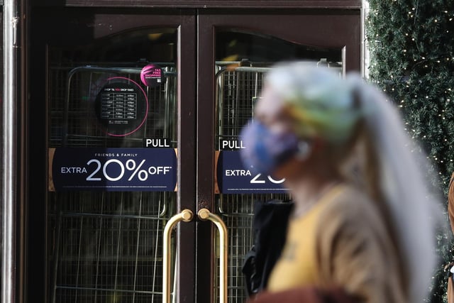 A woman walks past the closed House of Fraser store on Buchanan Street in Glasgow.