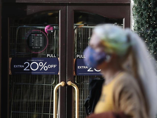 A woman walks past the closed House of Fraser store on Buchanan Street in Glasgow.