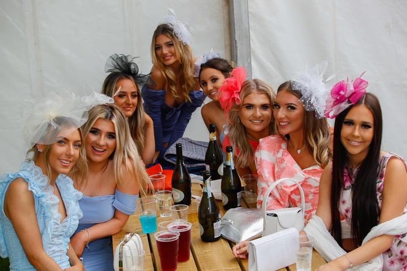 The gals having a glam fun time as they enjoy the races together.