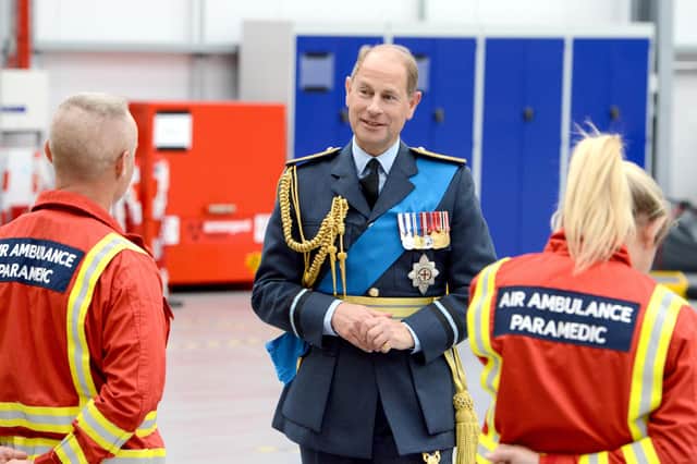 Prince Edward meets a couple of air ambulance paramedics at the charity's new headquarters.