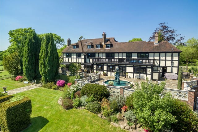 Occupying an elevated position in the pretty village of Bolney, this house has been sympathetically extended over the years and includes a number of attractive features, including an art studio, an indoor swimming pool, a tennis court, stables and a summer house. Price: £5,950,000.