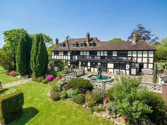 Occupying an elevated position in the pretty village of Bolney, this house has been sympathetically extended over the years and includes a number of attractive features, including an art studio, an indoor swimming pool, a tennis court, stables and a summer house. Price: £5,950,000.