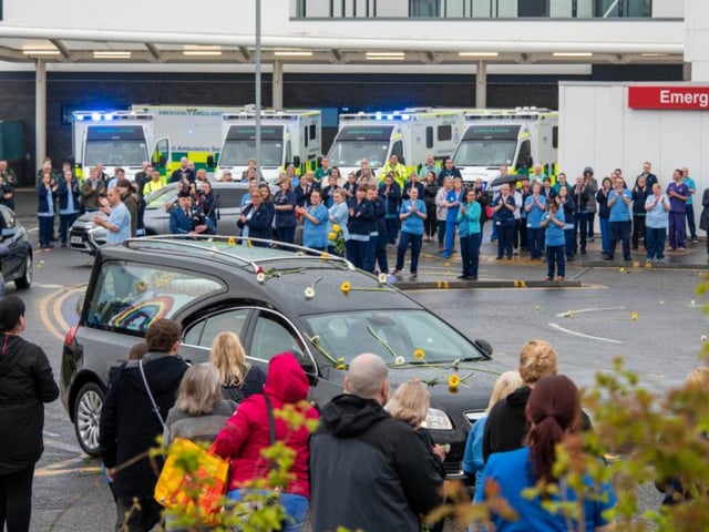Sunflowers were thrown onto the hearse as it went past the A&E department at the Royal Infirmary.