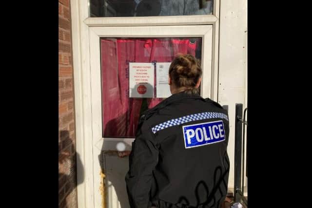 Police have shut down a house in Southey Green, Sheffield, because of concerns over drugs and anti-social behaviour. PC Alice Boucher is pictured issuing the papers earlier today.