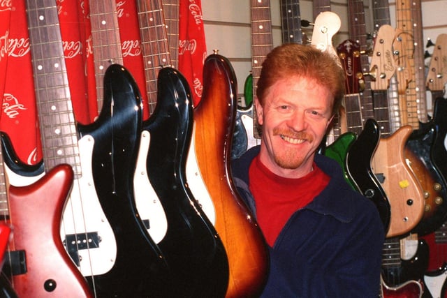 Glenn Hibbertson with bass guitars at his guitar shop, Wavelength, on London Road, back in 1998