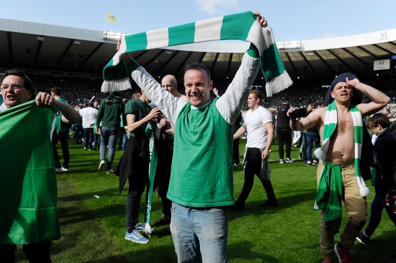 Whether it s retro shirts, replica strips or no shirt at all - Hibs fans showed their colours for the memorable moment. 
Pic: Neil Hanna
