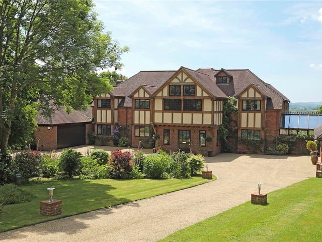 Enjoying a wonderful rural location in an Area of Outstanding Natural Beauty, this substantial country house has been designed and finished to an exceptional standard, and features its own cinema, games room and tennis court. Price: £3,650,000.