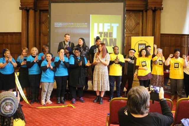 Asylum seekers and supporters clap after cutting a ribbon together to launch the Lift the Ban Coalition campaign at Sheffield Town Hall. Picture: Lift the Ban