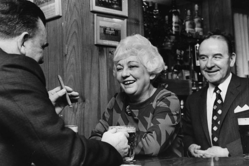Edith Coulson, manageress of Albermale public house chatting to customers in January 1971.