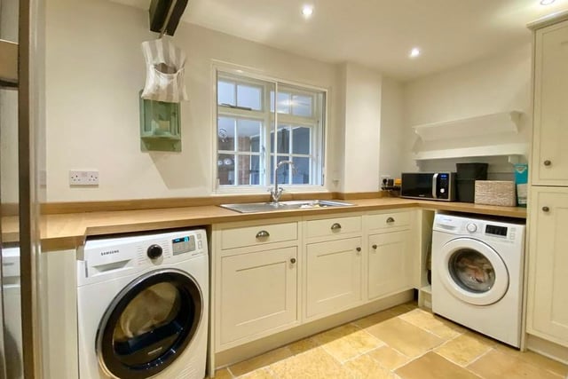 Before we leave the main property, let's take a look at this useful utility room. Fitted with a corner larder unit, it has a single-drainer stainless steel sink unit, plumbing space for a washing machine and tumble dryer, and space for an American fridge freezer.