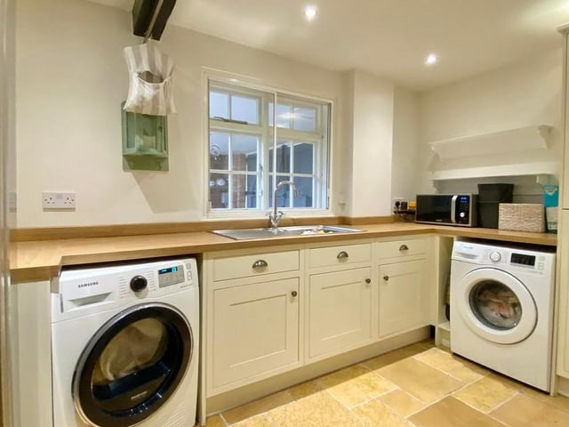 Before we leave the main property, let's take a look at this useful utility room. Fitted with a corner larder unit, it has a single-drainer stainless steel sink unit, plumbing space for a washing machine and tumble dryer, and space for an American fridge freezer.