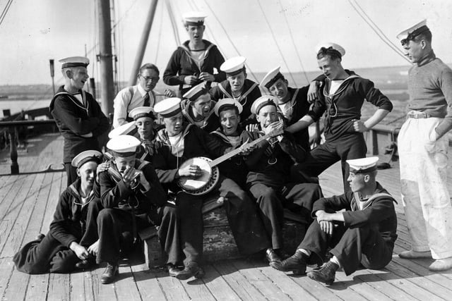 20th August 1936:  Sea Cadets on board the training ship HMS Implacable at Portsmouth harbour, amuse themselves by playing some tunes.  (Photo by E. Dean/Topical Press Agency/Getty Images)