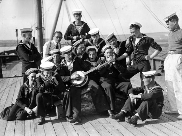 20th August 1936: Sea Cadets on board the training ship HMS Implacable at Portsmouth harbour, amuse themselves by playing some tunes. (Photo by E. Dean/Topical Press Agency/Getty Images)