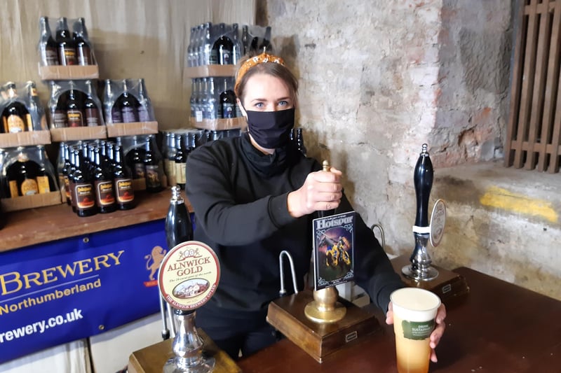 Phillipa Jasinek, brewer at the Alnwick Brewery, pulls a pint for a customer.