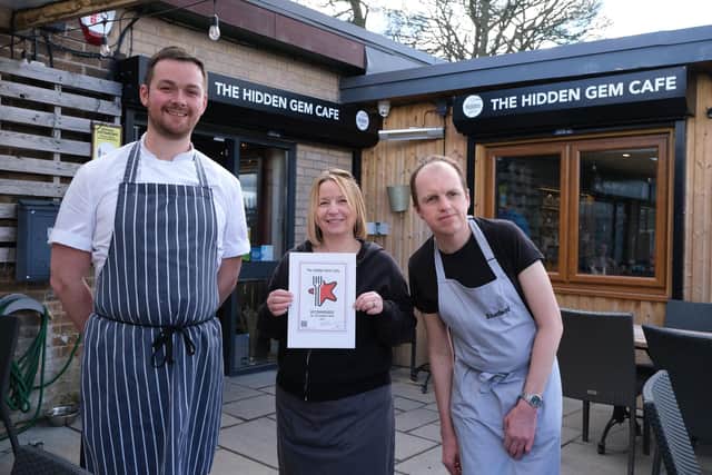 The Hidden Gem Cafe has won Restaurant Guru's 'recommendation badge'. Pictured is chef Sam, assistant manager Abi, and Jonathan with the award.