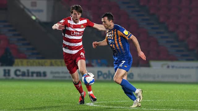 Tom Anderson puts the pressure on Shrewsbury's Shaun Whalley. Picture: Andrew Roe/AHPIX