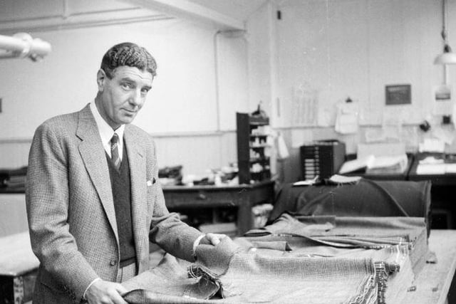 George Roberts & Co Ltd, tweed mill, August 1962. Mr H. Rae examines cloth.