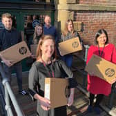 Tapton School headteacher Kat Rhodes, front, and deputy-headteacher Harkiran Grewal, right, with director Chris Booker, rear, and team at DeeperThanBlue, which has donated 15 laptops to the school.