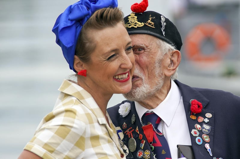 D-Day veteran Joe Cattini kisses a member of the Charlalas as he and other veterans are welcomed to the Portsmouth Historic Dockyard to commemorate the 77th anniversary of the Normandy Landings. Picture: Steve Parsons/PA Wire